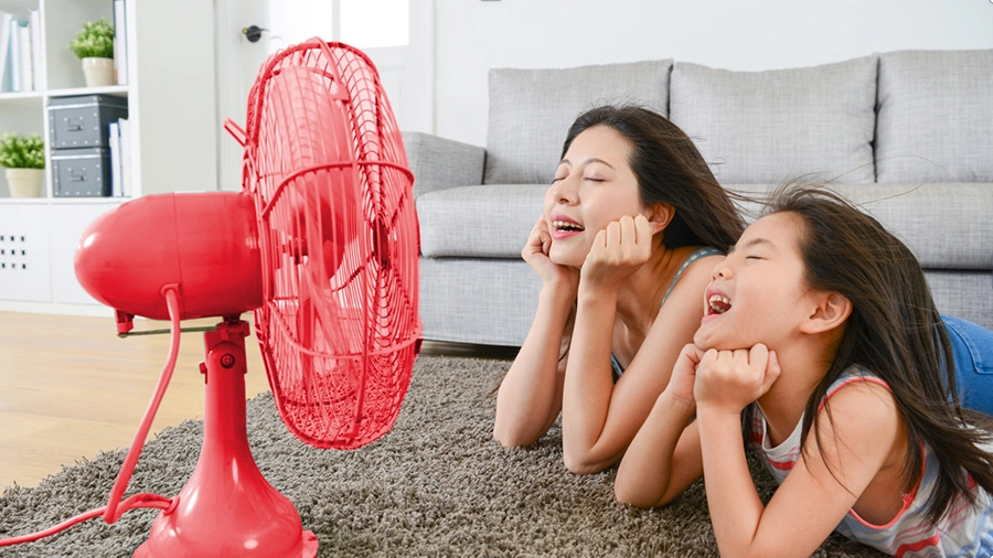 Mom and Daughter with a fan on a hot day